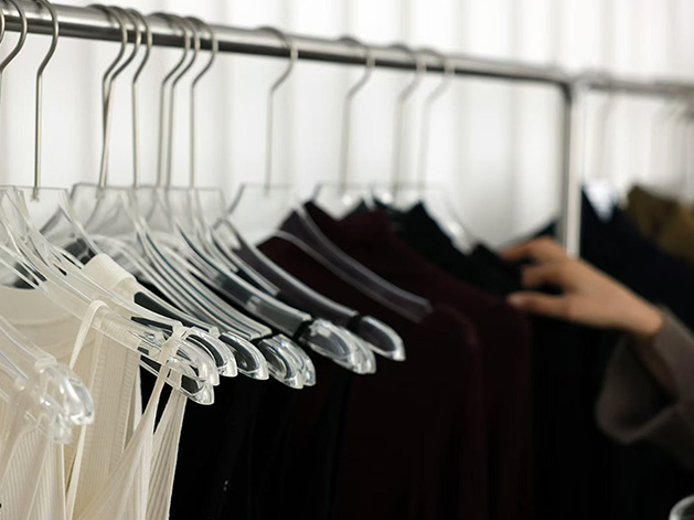 Premium seamless knitwear in ivory, burgundy and black on acrylic hangers at the Cawoolyang showroom